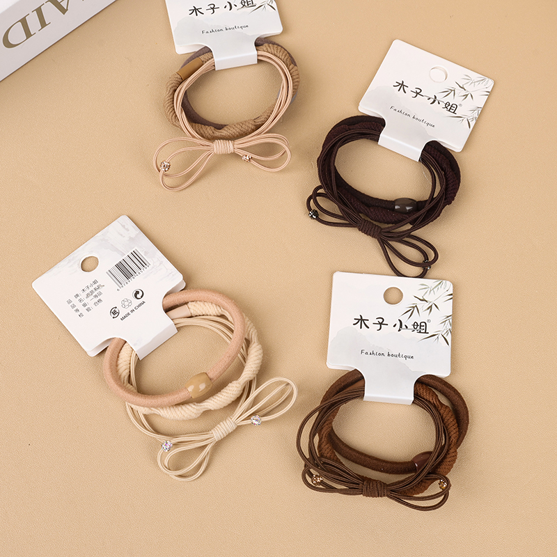 Three milk tea colored knotted rubber bands